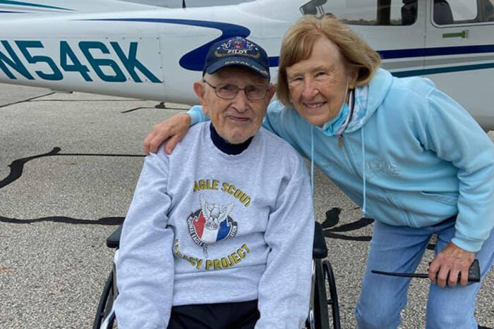 resident navy pilot in front of plane