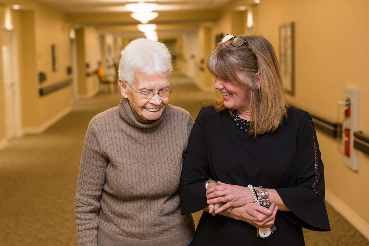 Danbury Caregiver walking with a memory care resident 
