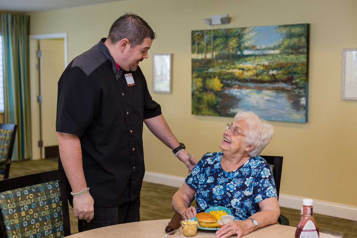 StoryPoint resident talking someone in the dining room