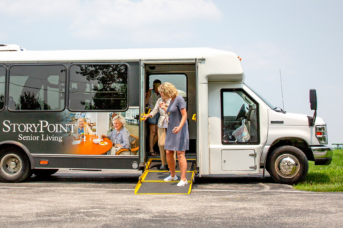 Caregiver helping StoryPoint resident off bus