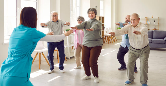 seniors squatting with therapist