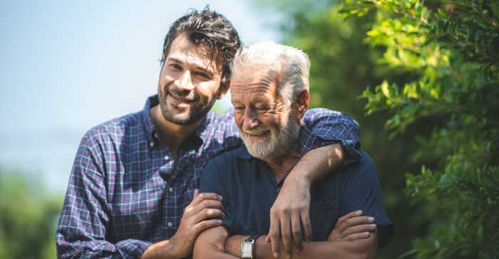 son and memory care resident walking outside