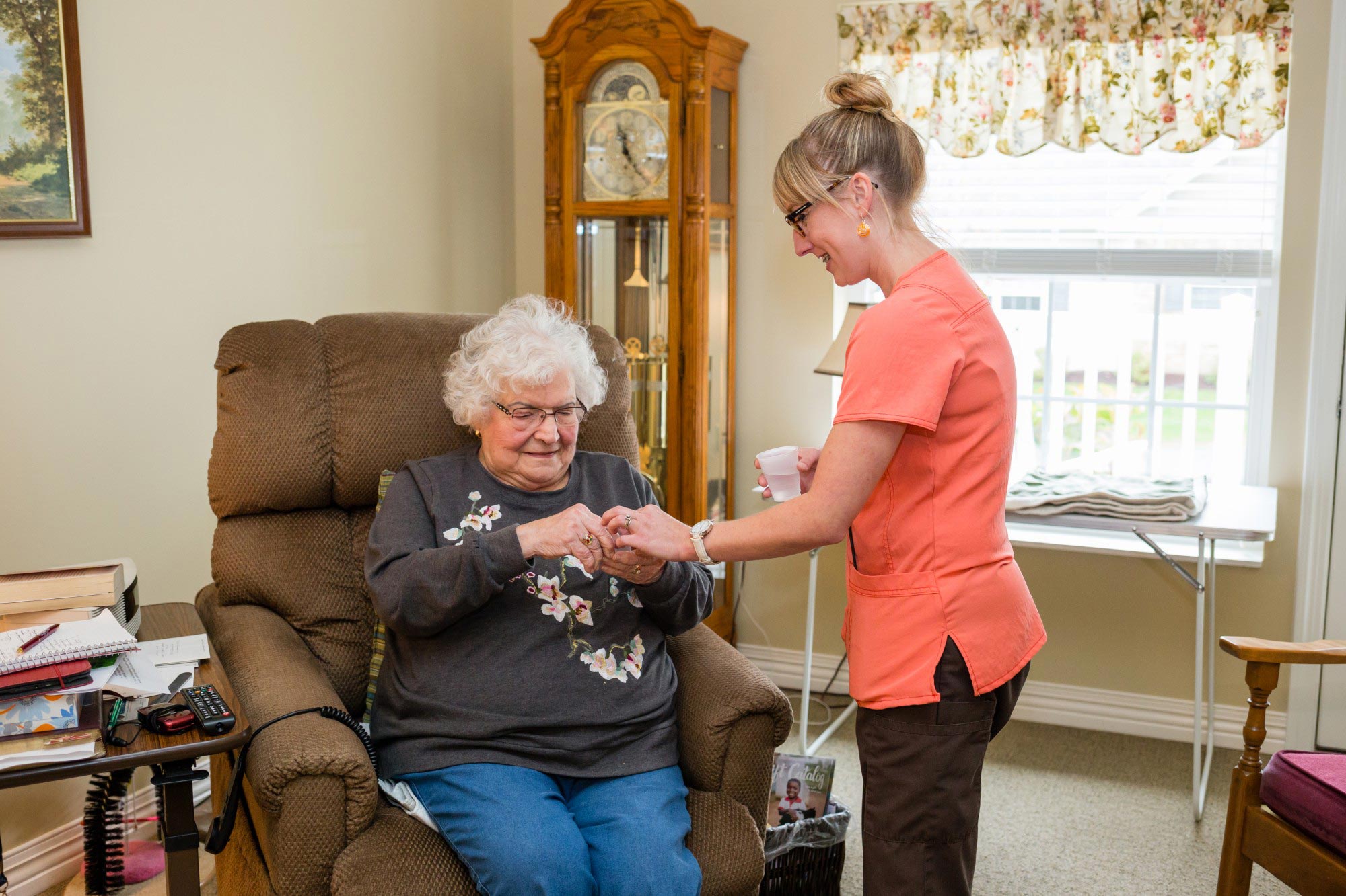 caregiver helping a StoryPoint memory care resident with medication