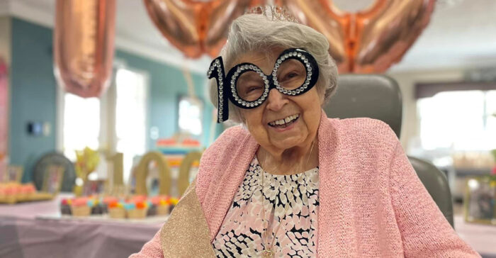 senior woman with 100th birthday glasses