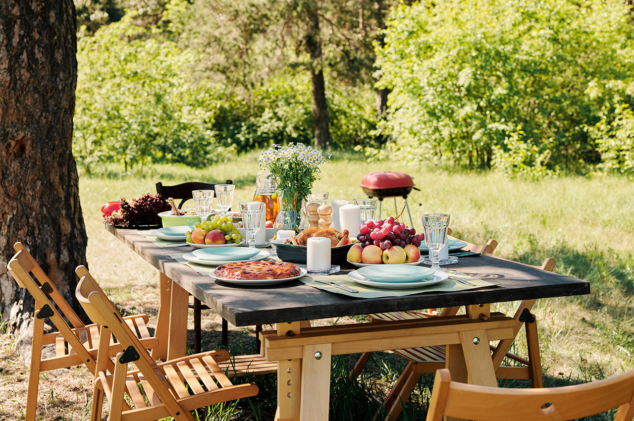 picnic table set with food and drinks 