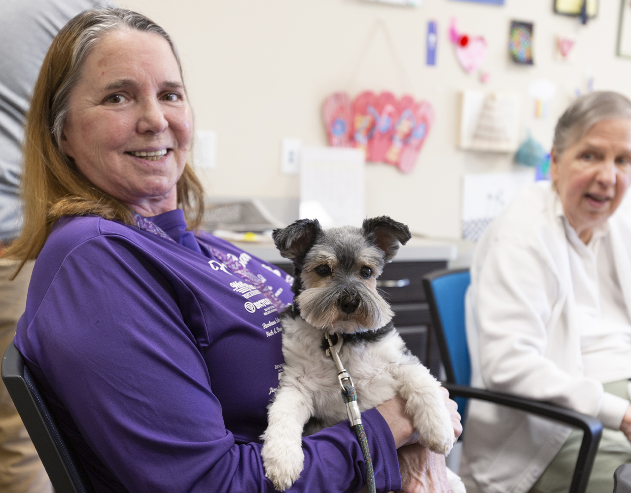 woman holding dog in her lap