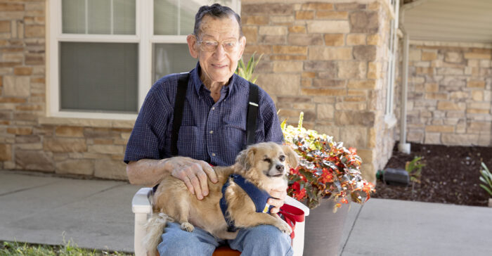 StoryPoint resident with dog on his lap