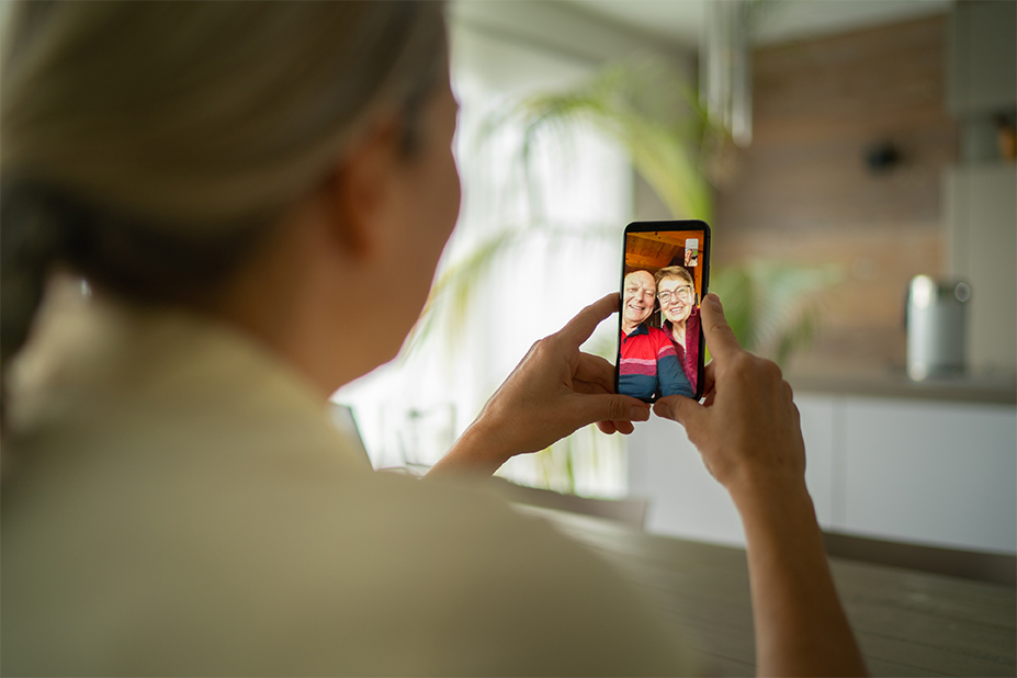 woman video calling with senior parents