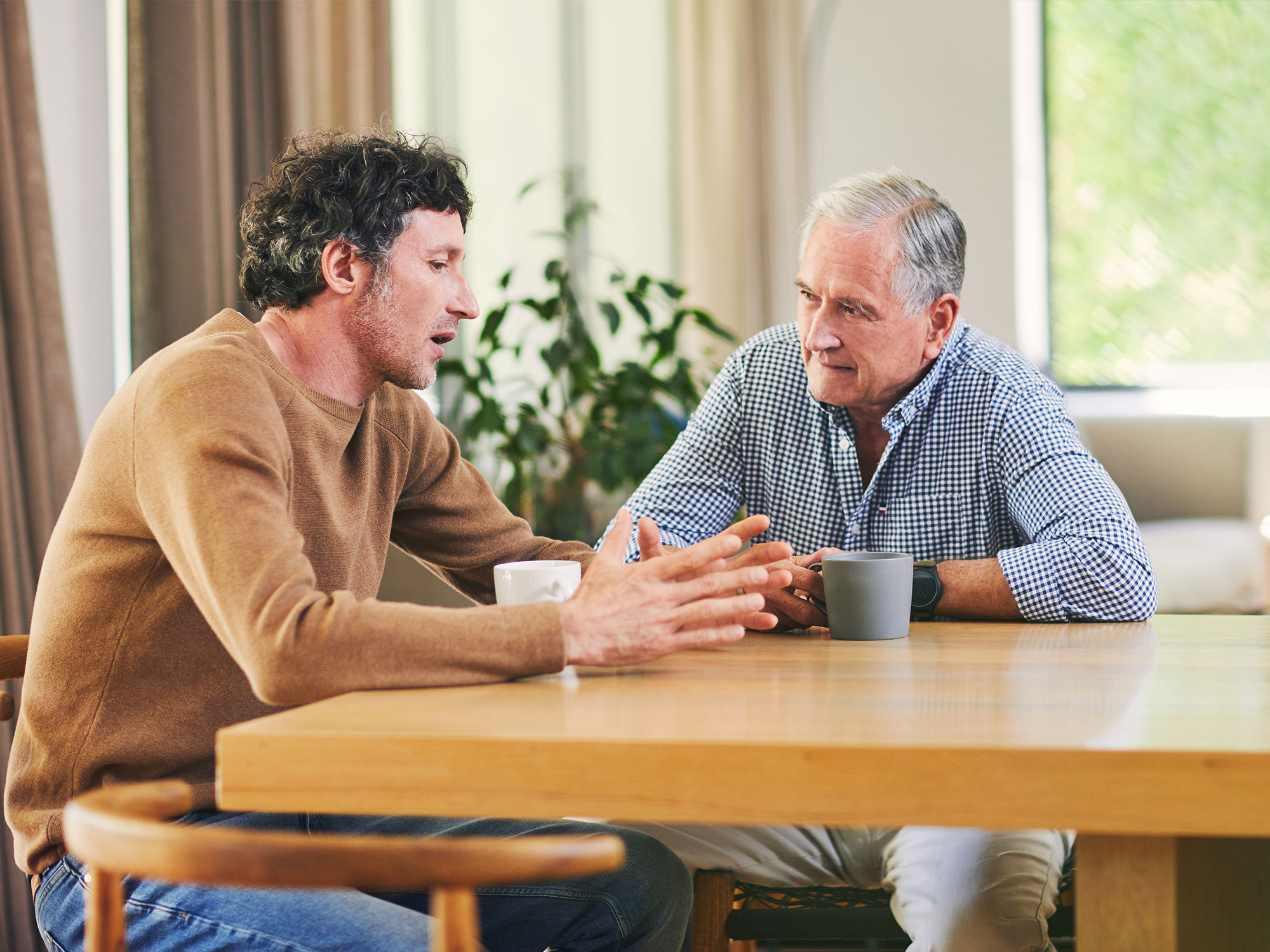 elderly father and son talking 