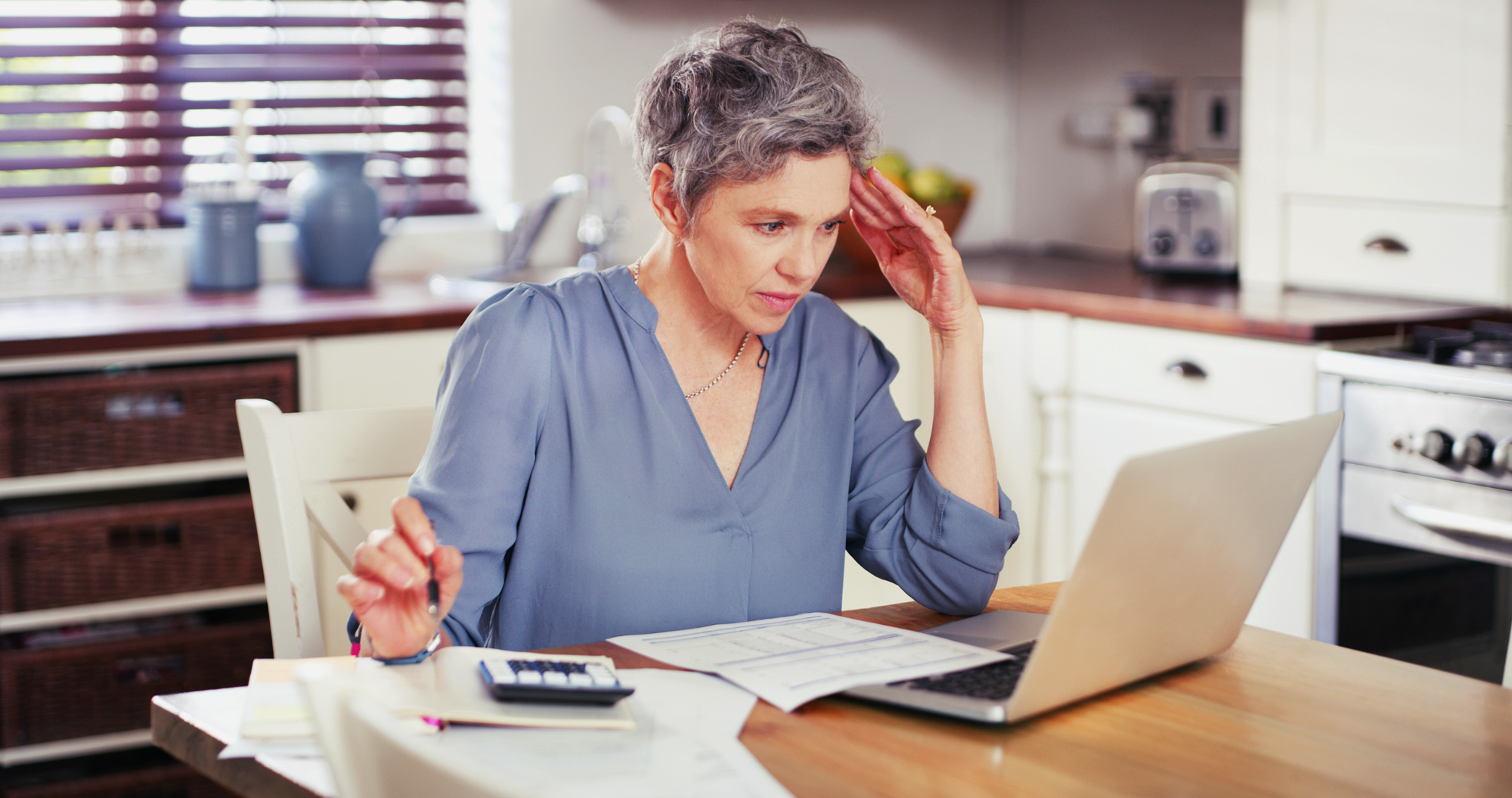 senior woman on the computer budgeting for home health costs